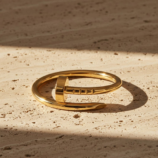 Gold nail-inspired fashion ring with glossy finish